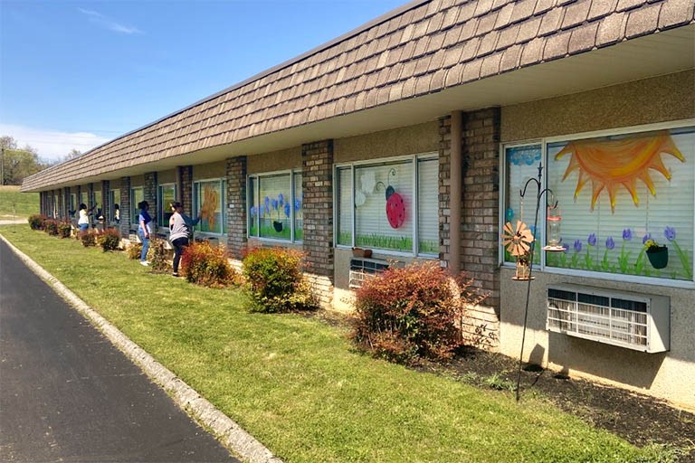 Volunteers, associates paint residents’ windows at Life Care of Morristown